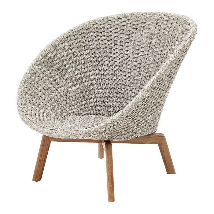 Beige woven chair with a smooth, rounded design and natural wood legs, creating a modern and cozy aesthetic.