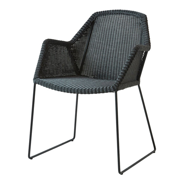 Black woven armchair with a modern geometric pattern and sleek metal legs. Perfect for contemporary decor.
