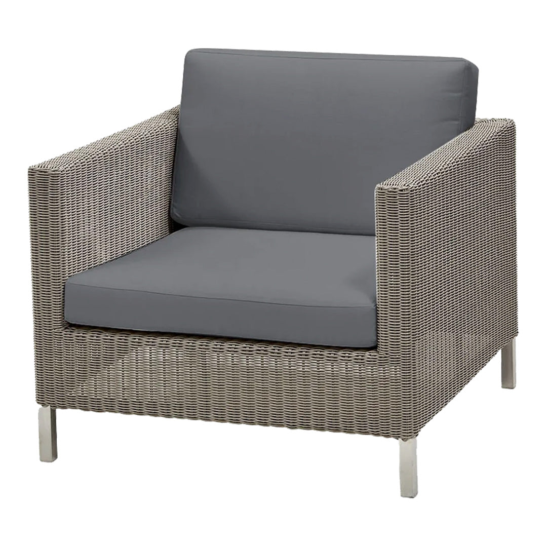 Gray cushioned chair with woven light gray rattan and sleek silver metal legs; modern, versatile design.