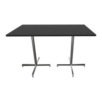 Black tabletop with sleek stainless steel legs, showcasing a minimalist and modern design. Perfect for contemporary spaces.