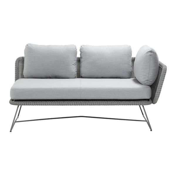 Light gray woven outdoor sofa with plush cushions and sleek metal frame. Modern design and neutral color palette.