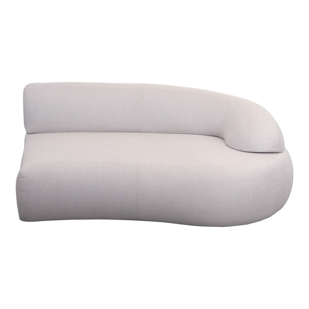 Curved, modern chaise lounge in soft beige fabric with a smooth, minimalistic design for stylish interiors.