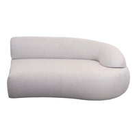 Curved, modern chaise lounge in soft beige fabric with a smooth, minimalistic design for stylish interiors.