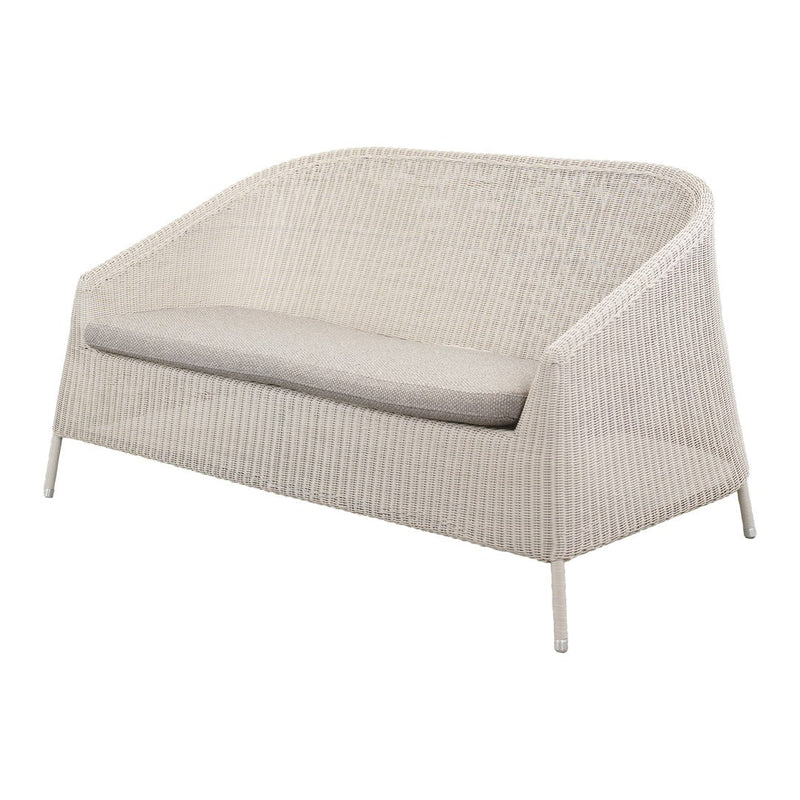 White woven patio loveseat with light gray cushion, featuring a modern, minimalist design. Perfect for outdoor spaces.