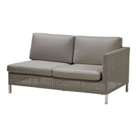 Gray two-seater sofa with plush cushions and a textured woven fabric base, accented by sleek metal legs.