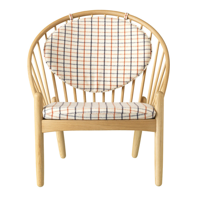 Beige and white checkered pattern with orange accents on a wooden chair with a curved design.