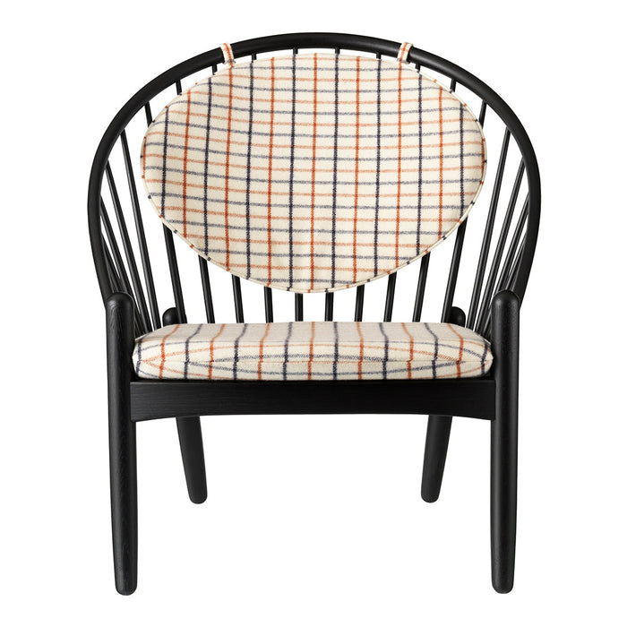 Black chair with a rounded back featuring a cream and orange grid pattern. Stylish modern design for any decor.
