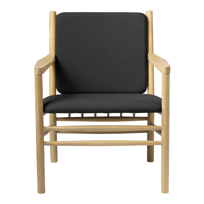 Modern chair with a natural wood frame and sleek black cushion, creating a minimalist aesthetic.