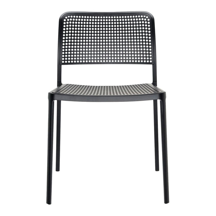 Black perforated dining chair with a sleek, minimalist design and a modern finish. Ideal for contemporary spaces.