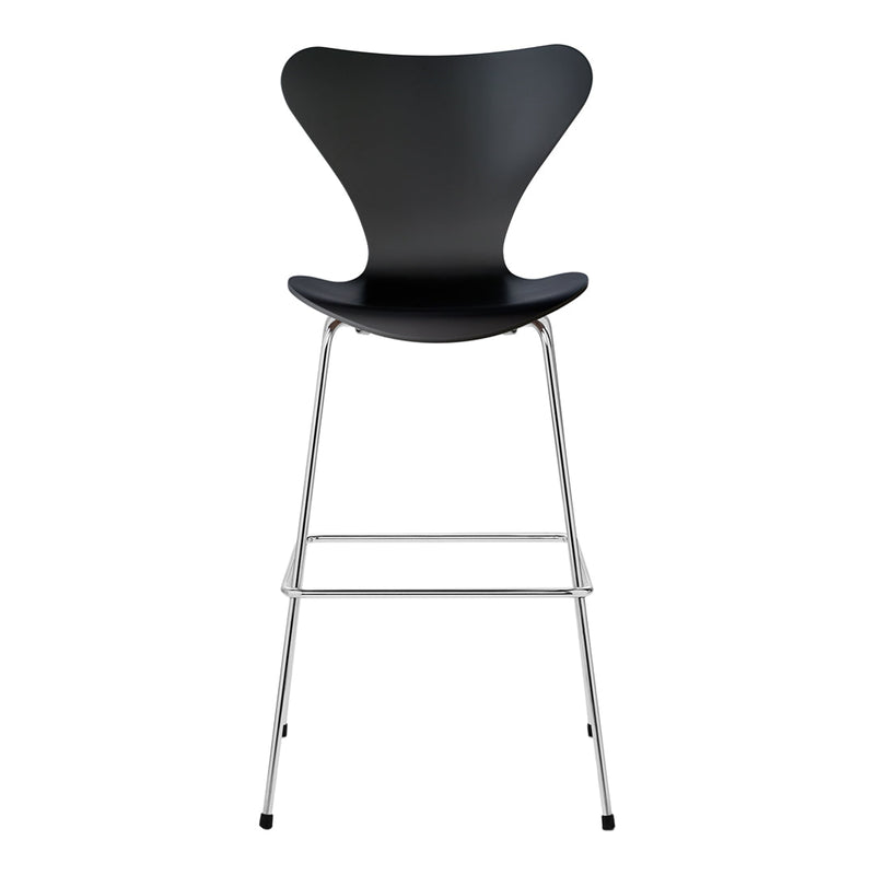 Black curved chair with a sleek design and silver metal legs, perfect for modern decor.