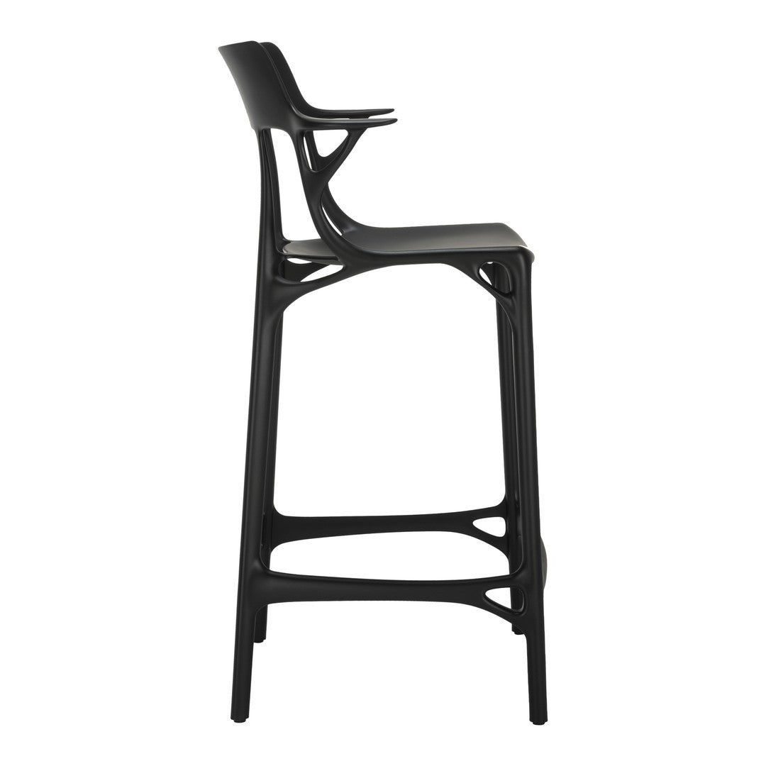 Black bar stool with a sleek, modern design and unique cut-out patterns. Ideal for contemporary decor.