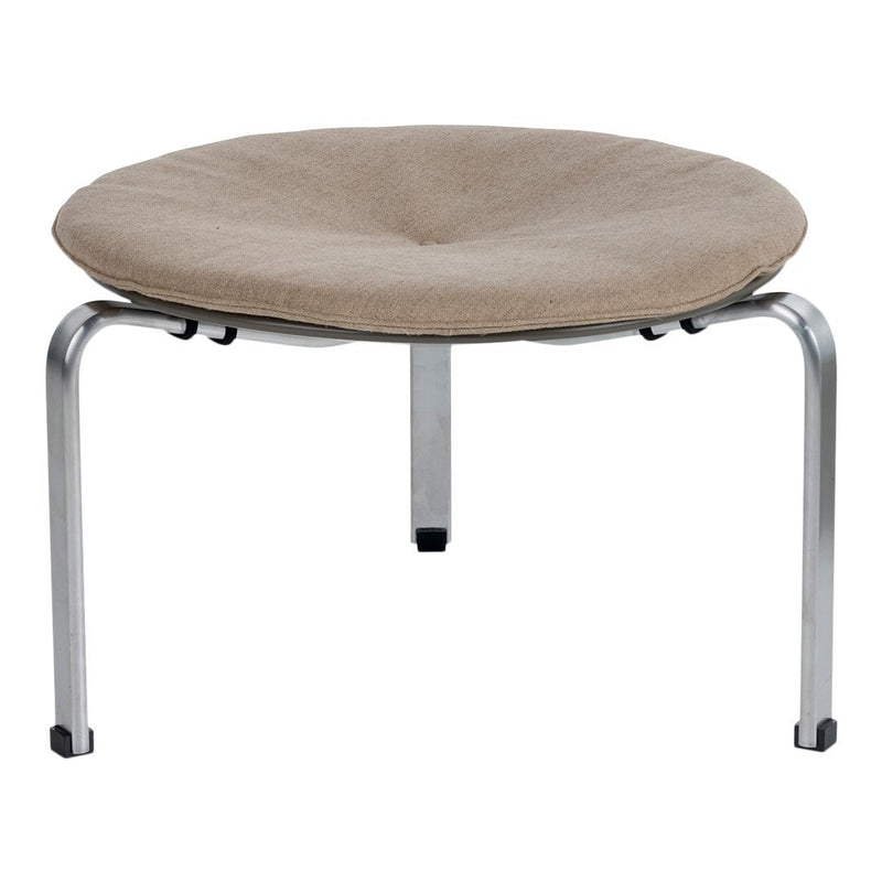 Round beige cushioned stool with a smooth fabric surface and metallic silver legs. Stylish and modern design.
