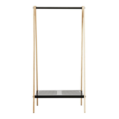 Minimalist clothing rack in natural wood and black with a perforated metal shelf. Modern and stylish design.