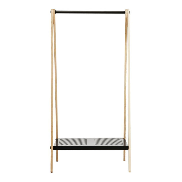Minimalist clothing rack in natural wood and black with a perforated metal shelf. Modern and stylish design.
