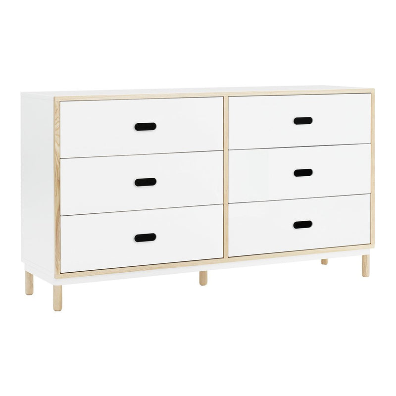 "White dresser with four drawers, gold accents, and black handles for a modern, minimalist look."