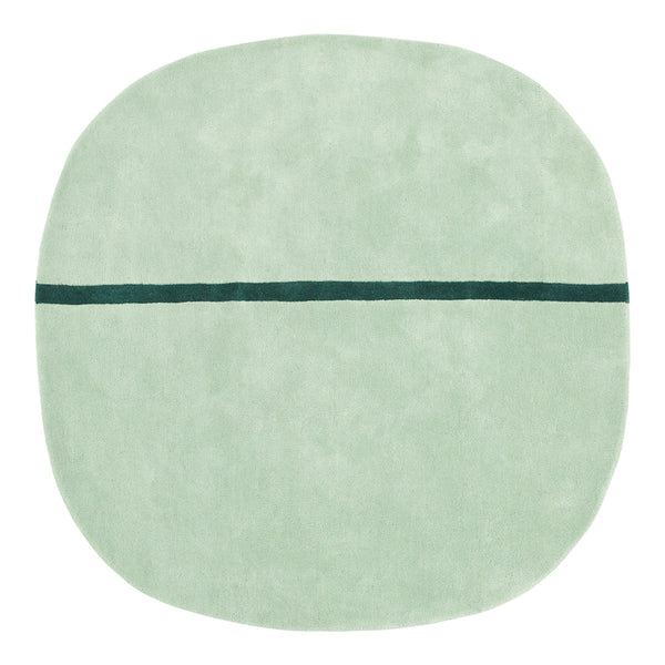 Soft mint green round rug with a contrasting dark teal line pattern across the center.