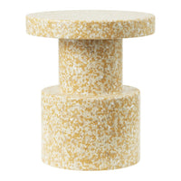 Textured yellow and white speckled side table with a modern cylindrical design, ideal for contemporary interiors.