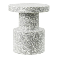 Gray speckled side table with a minimal, modern design and smooth circular top and cylindrical base.
