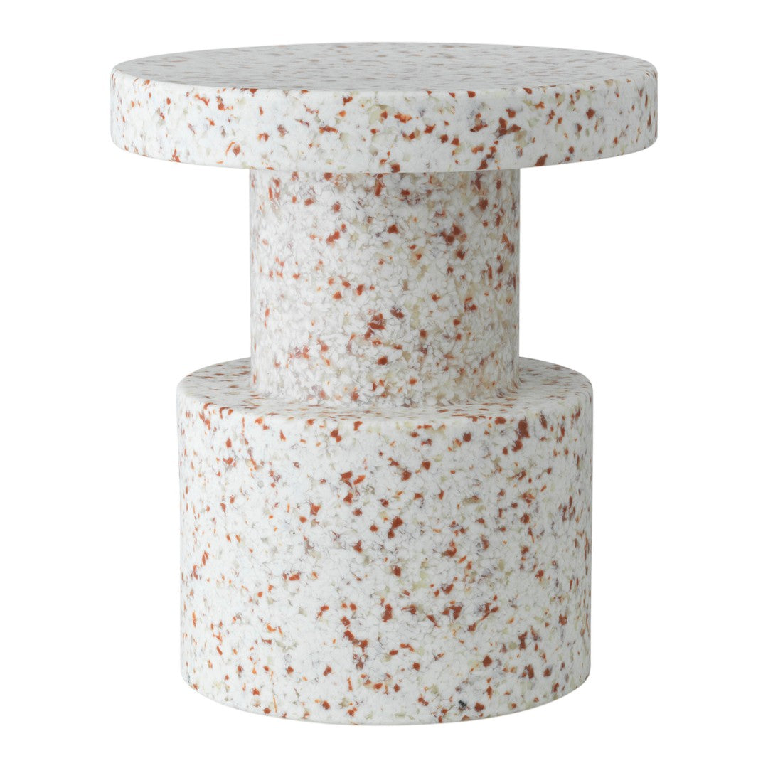 White terrazzo table with subtle speckles in warm tones of orange and brown, featuring a modern geometric design.