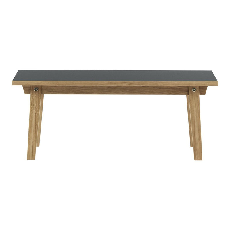 Stylish black tabletop with natural wood grain legs, showcasing a modern and minimalist design. Perfect for any space.