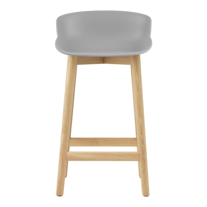 Gray plastic stool with natural wood legs, featuring a sleek minimalist design and smooth, curved edges.
