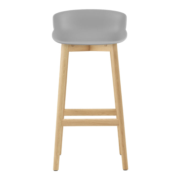 Gray bar stool with a smooth, contoured seat and natural wood legs, offering a sleek and modern design.