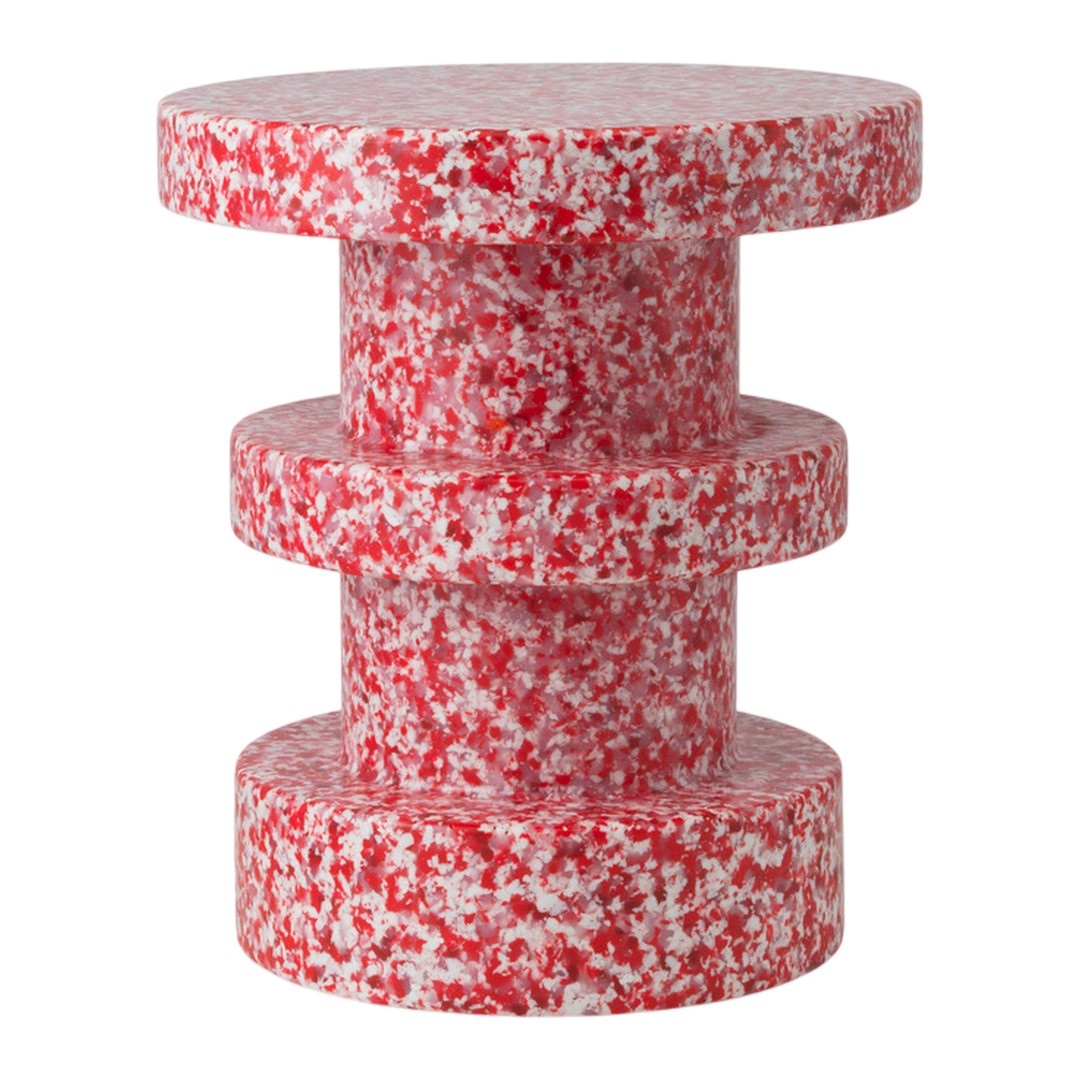 Red and white speckled accent table featuring a cylindrical, stacked design. Perfect for modern decor.