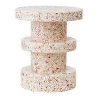 Round table with a textured finish in soft cream and pink hues, featuring a layered, cylindrical design.