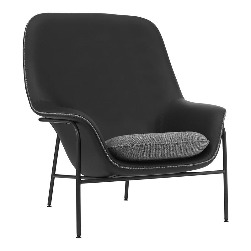 Stylish black armchair with a sleek gray cushion, featuring a minimalist design and soft curves.