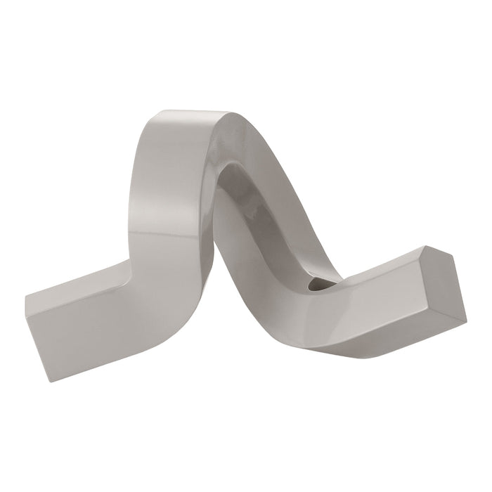 Sleek silver metal sculpture with a wavy design, featuring smooth surfaces and a glossy finish.