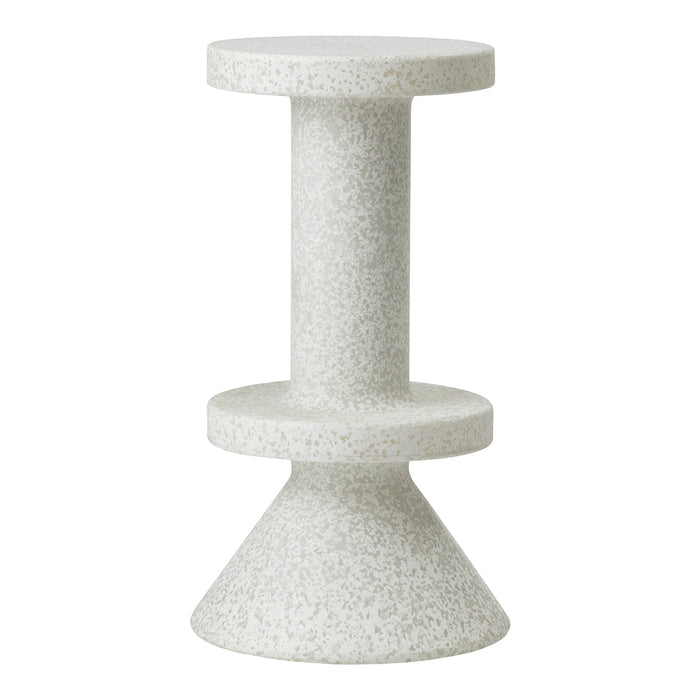 Minimalist gray and white speckled side table with a geometric design of cylindrical and conical shapes.