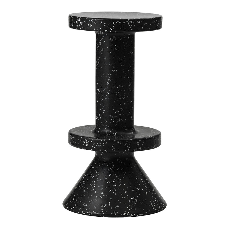Black speckled accent table with a cylindrical top and conical base, featuring a modern and sleek design.