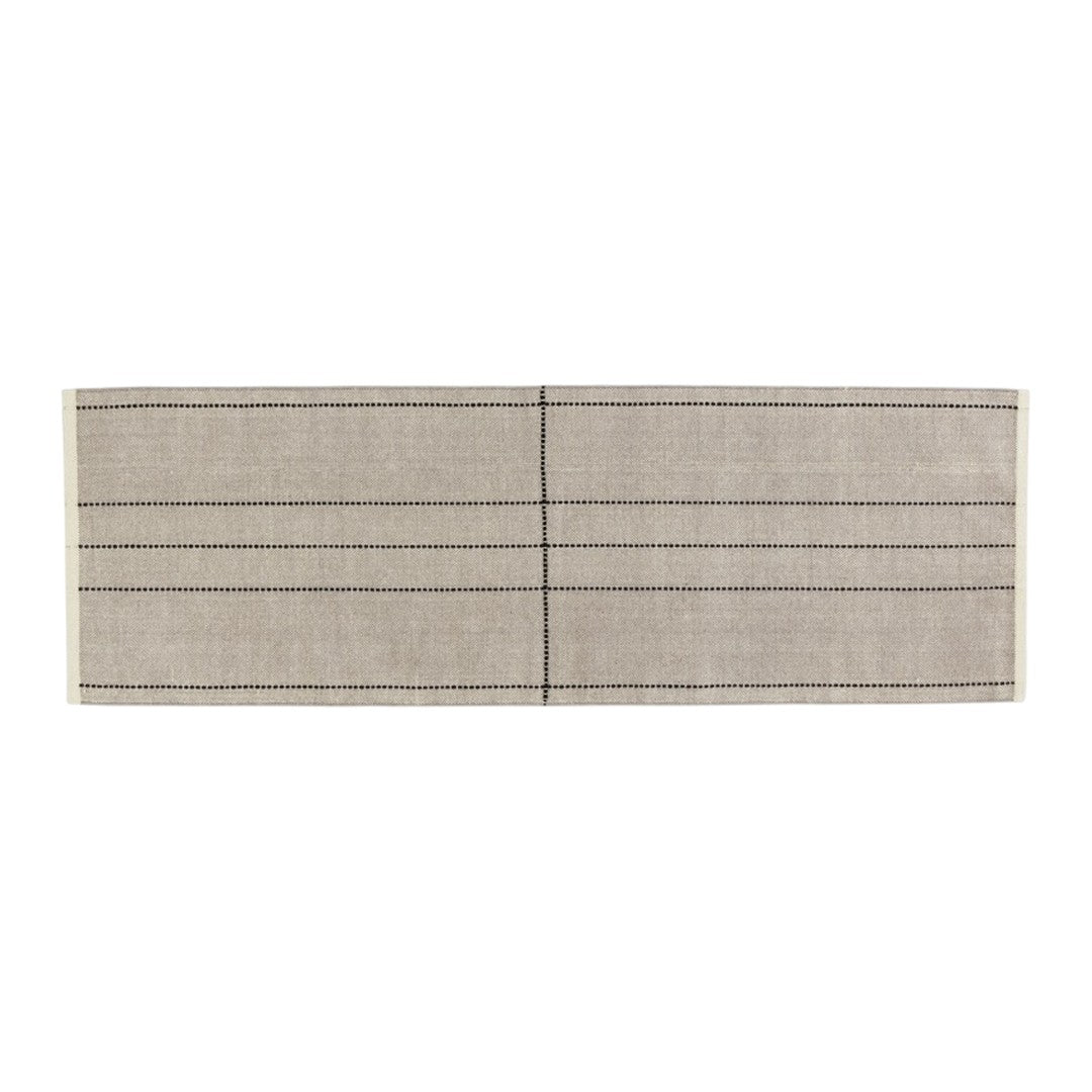 Beige runner rug with black dotted lines and stripes in a contemporary design. Perfect for minimalist decor.