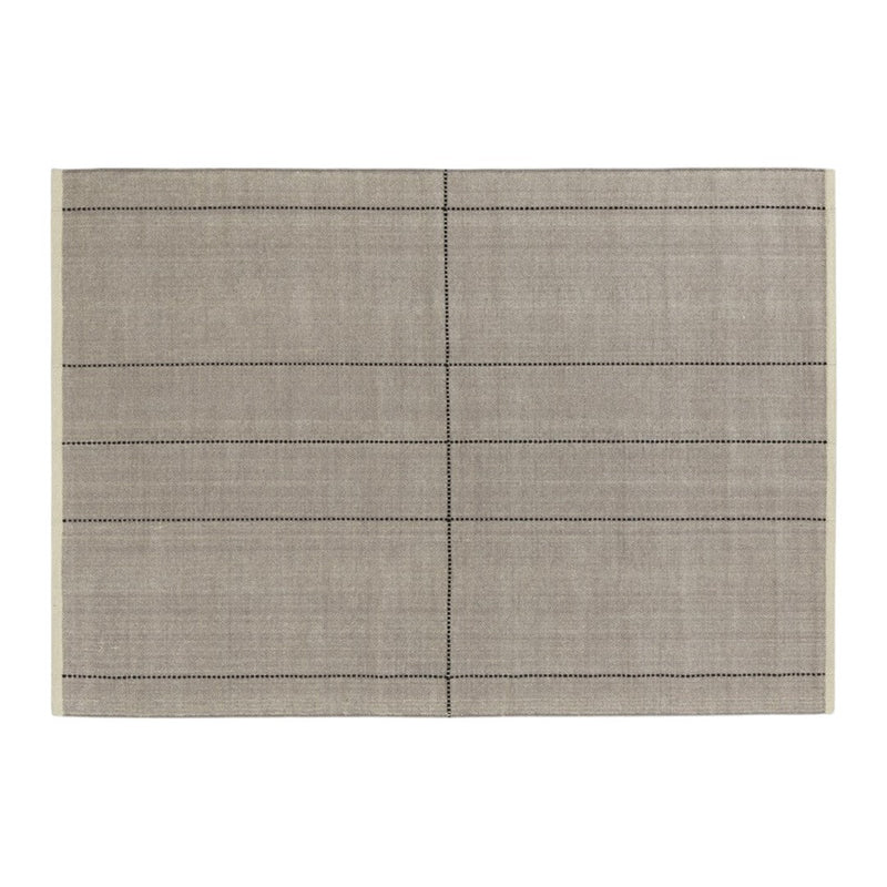 Gray placemat with a subtle texture and black dotted lines creating a grid pattern for a modern table setting.
