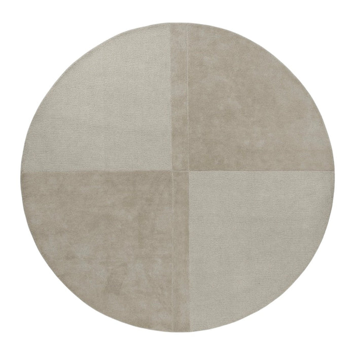 Round rug featuring a soft beige color with a subtle patchwork pattern in varying textures. Ideal for any modern space.