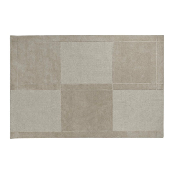 Beige rectangular rug with a patchwork design in varying shades of cream and light taupe. Soft, textured finish.