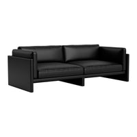 Stylish black leather sofa with sleek, minimalist design and smooth textures for modern living spaces.