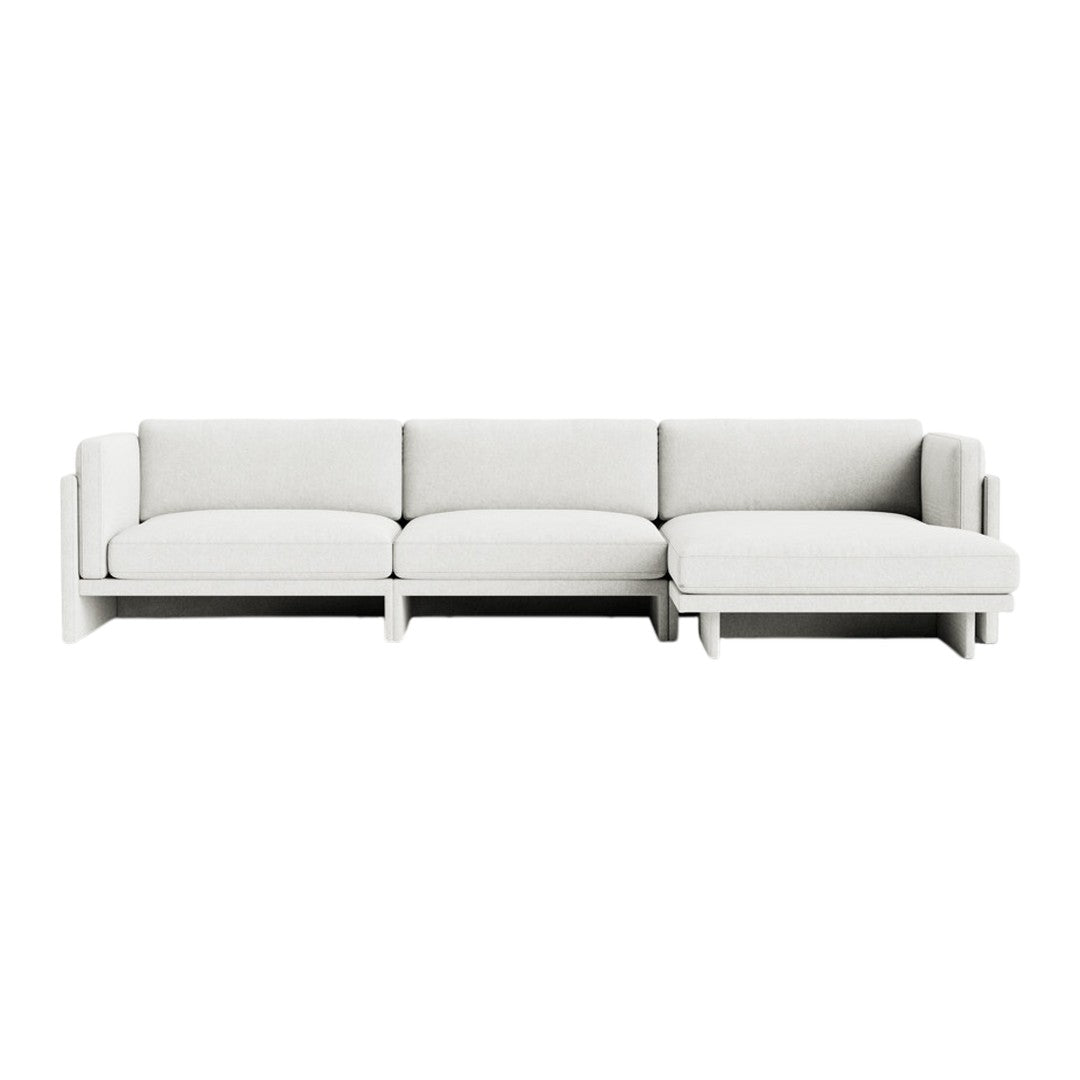 Modern, plush sectional sofa in a soft, neutral white fabric, featuring clean lines and minimalist design.