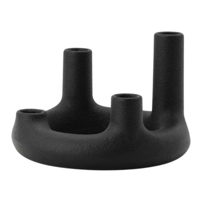 Black candle holder with unique shapes and textured matte finish, designed for modern home decor.