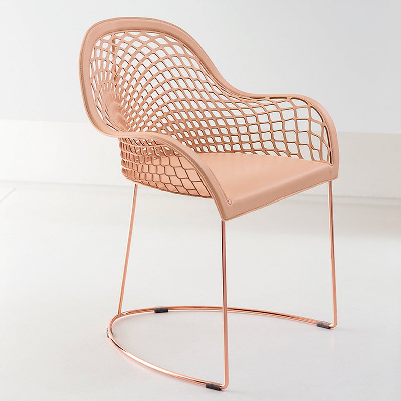 "Peach mesh chair with rose gold legs, featuring a modern, open grid pattern for a stylish accent."