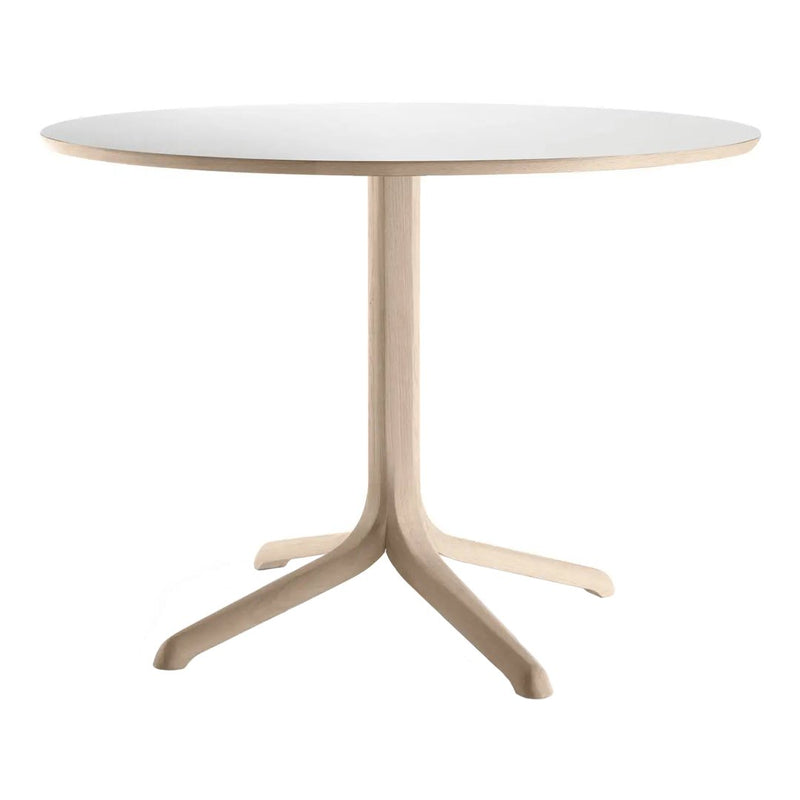 Round white tabletop with a natural wood base, featuring a sleek, minimal design and smooth, soft finish.