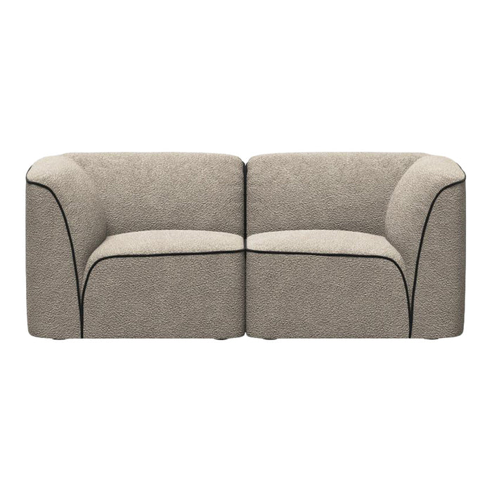 Beige two-seater sofa with textured fabric and contrasting black piping detail. Elegant and modern design.