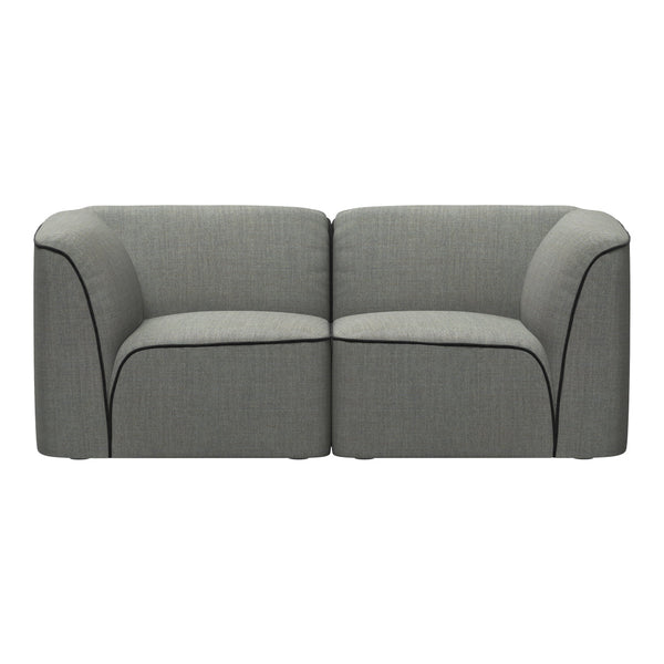 Gray upholstered sofa with smooth texture and contrasting black piping along the edges.