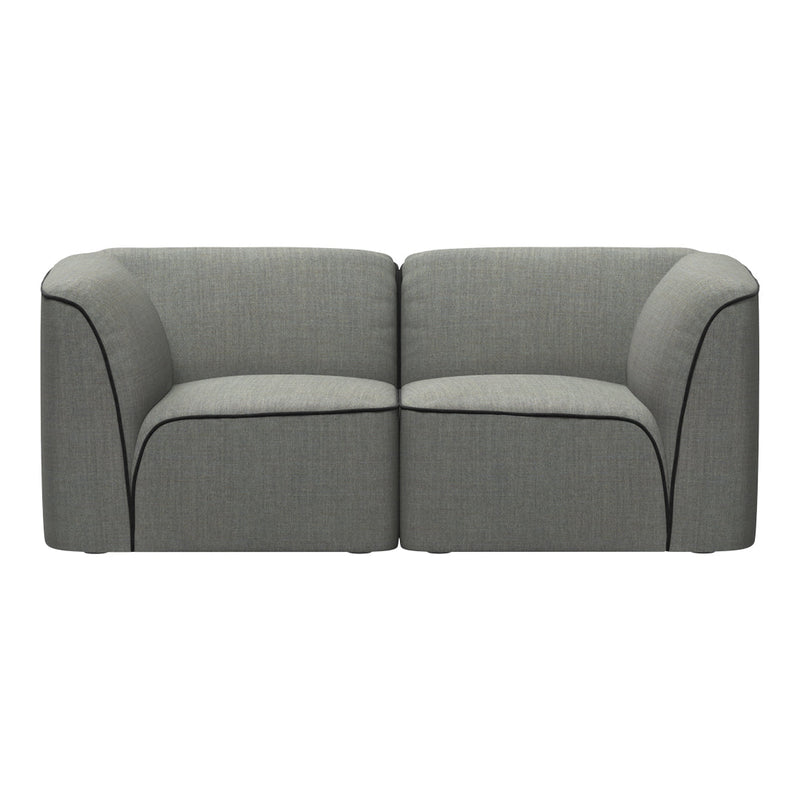 Gray upholstered sofa with smooth texture and contrasting black piping along the edges.