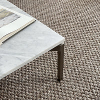 Gray marble coffee table with sleek metal legs, set against a textured beige woven rug.