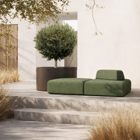 Modern green outdoor couch with soft, minimalist design, paired with a sleek dark planter against a neutral backdrop.