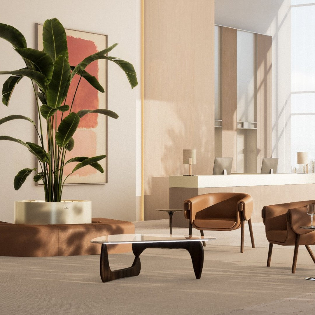 Modern living room featuring earthy tones, sleek black accents, and minimalist design with a touch of greenery.