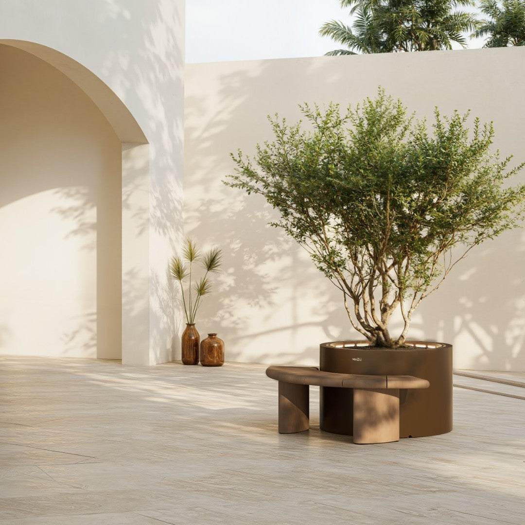 Modern brown bench and round planter against a soft beige backdrop with natural greenery and minimalist accents.