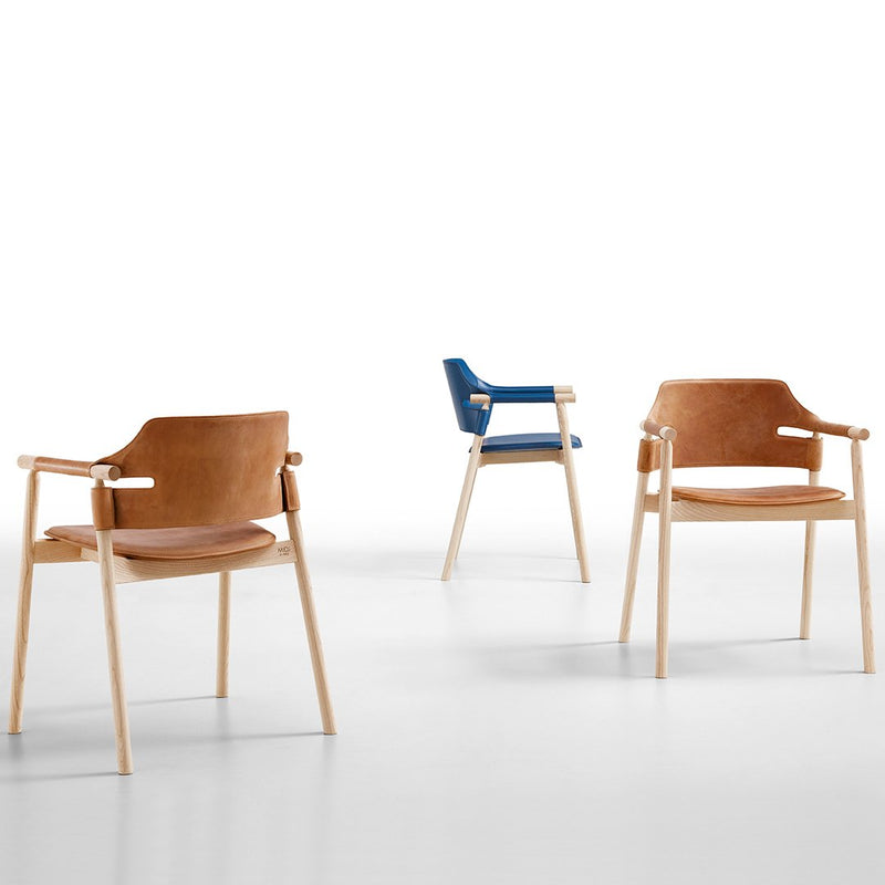 Set of three chairs featuring brown leather, a blue accent, and light wooden frames, showcasing a minimalist design.
