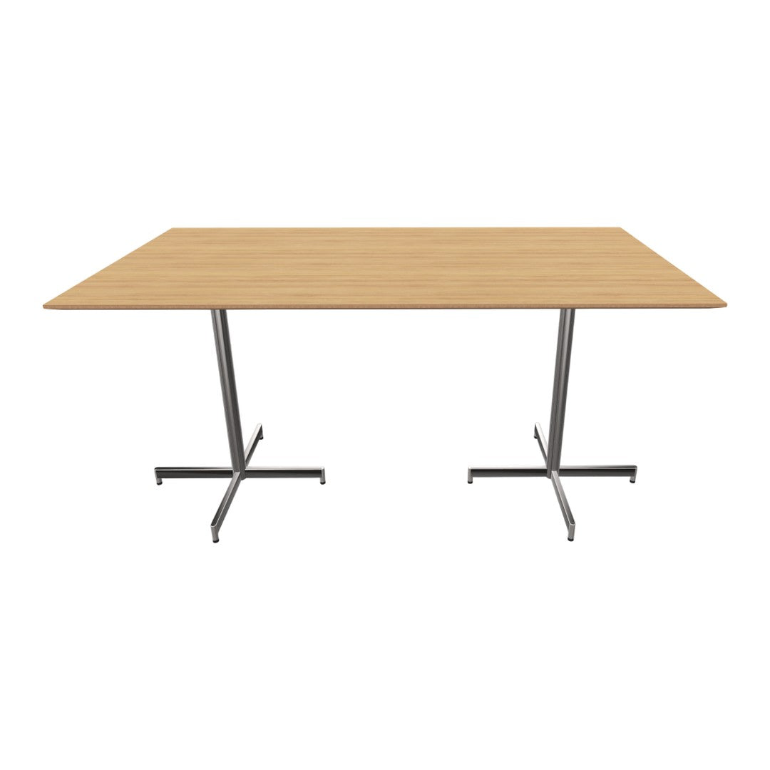 Modern wooden table with a light oak finish and sleek silver metal legs, featuring a minimalist design.